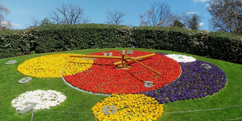 Flower clock in Geneva, Switzerland. L'horloge fleurie in French, outdoor flower clock located on the western side of Jardin Anglais park. Created in 1955 as a symbol of the city's watchmakers