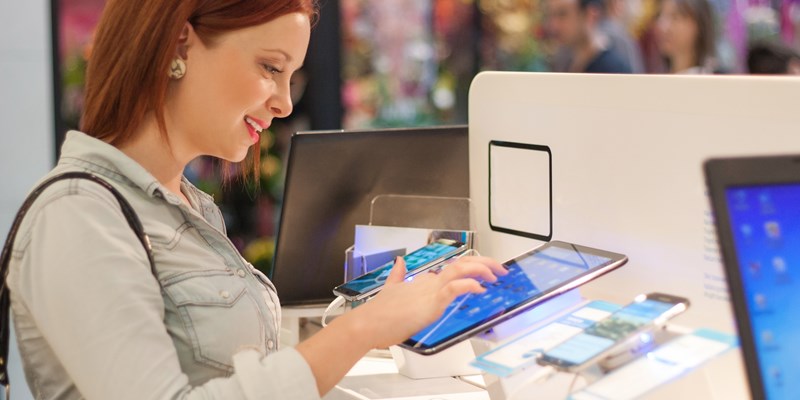 young Japanese mom choosing snack for kids in local specialty shop